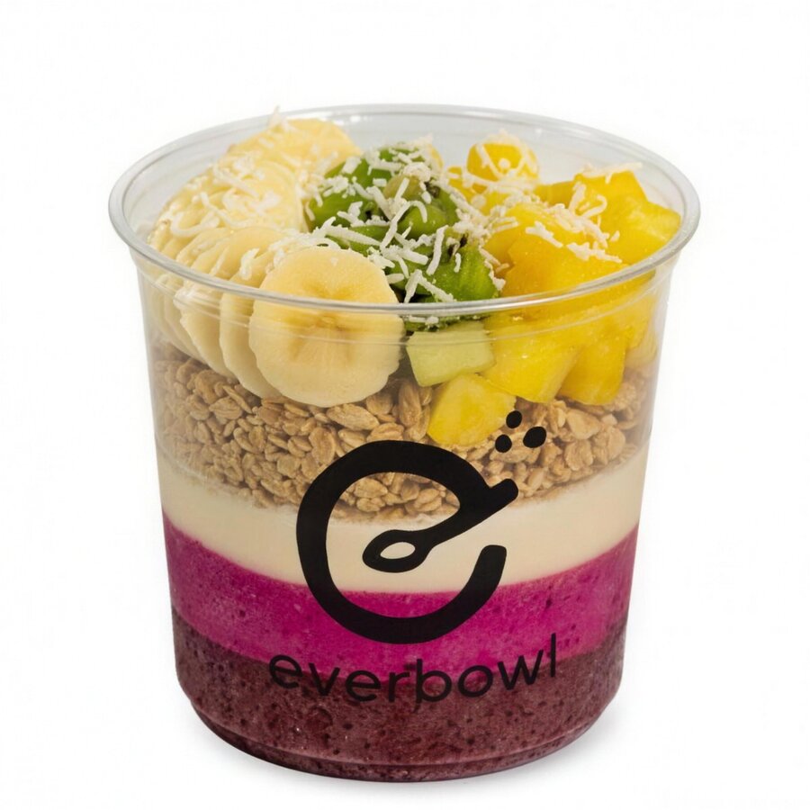 Pitayum bowl layering açaí, pitaya, and coco love with pineapple and kiwi